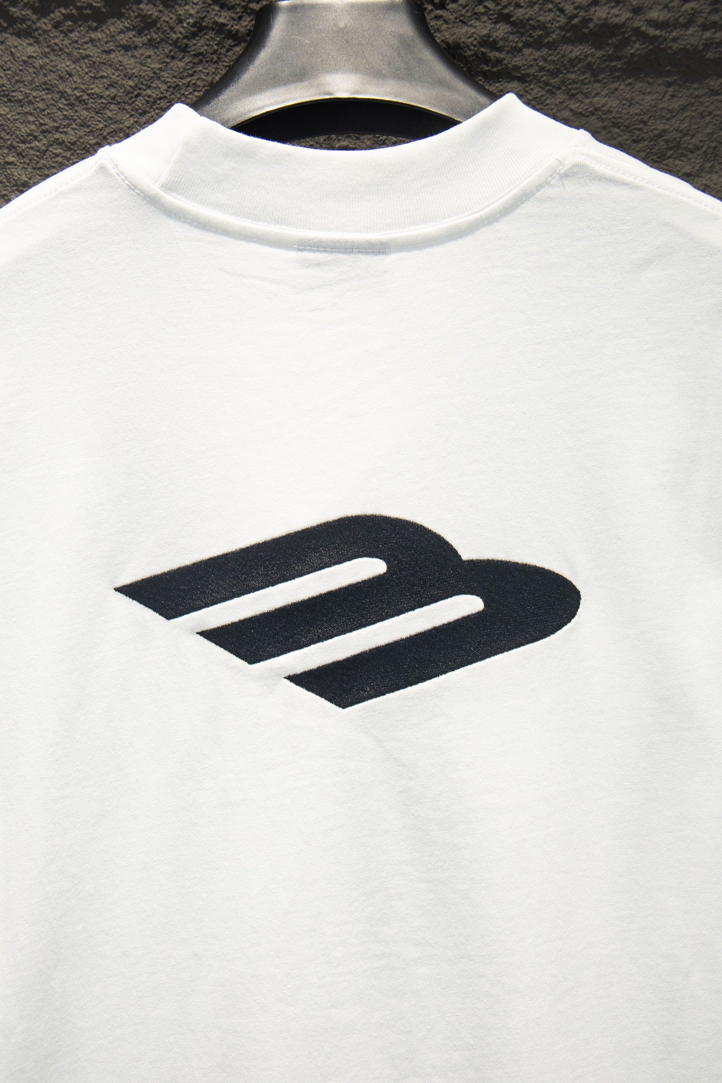 White T-shirt with oversized black Balenciaga logo print.