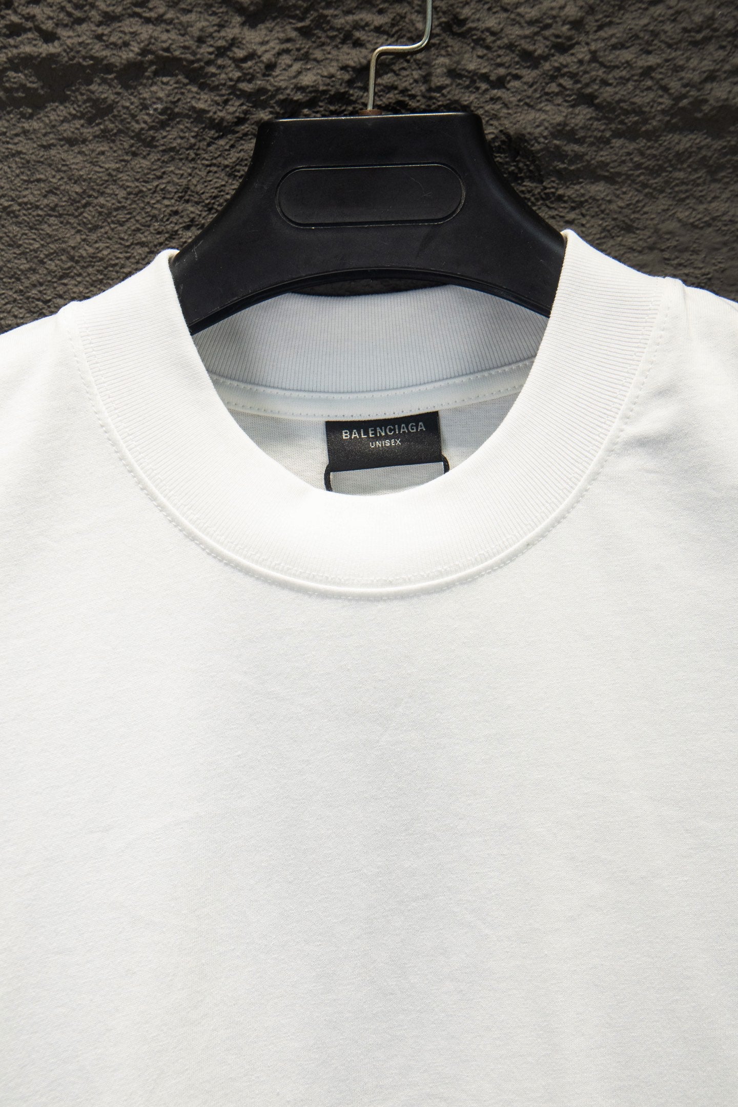 White crew-neck T-shirt collar with Balenciaga inner neck label.