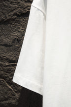 White short-sleeve T-shirt sleeve and side seam detail.