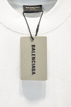 White T-shirt with Balenciaga inner neck label and attached product tag.