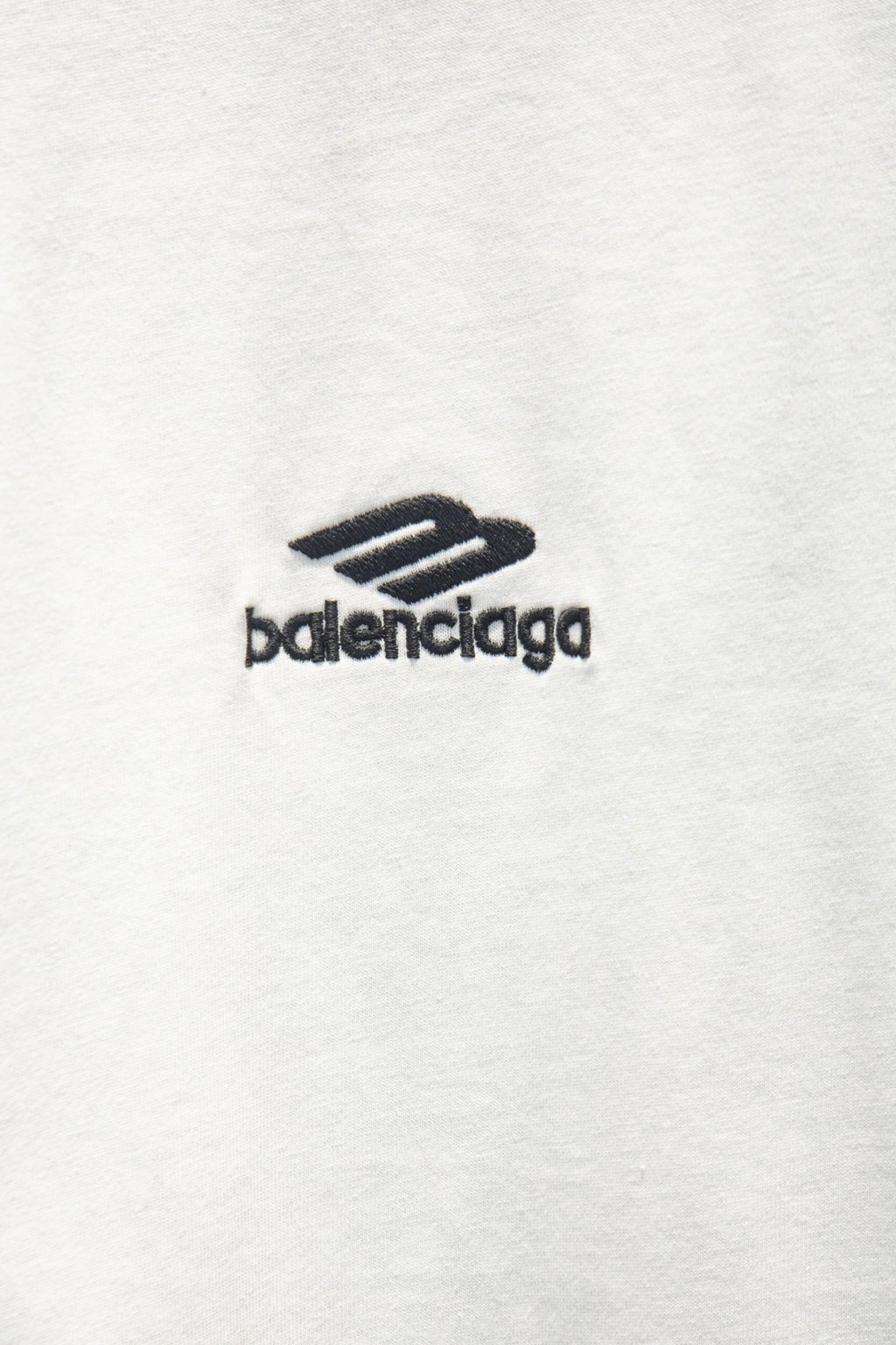 White T-shirt with small black balenciaga logo mark.