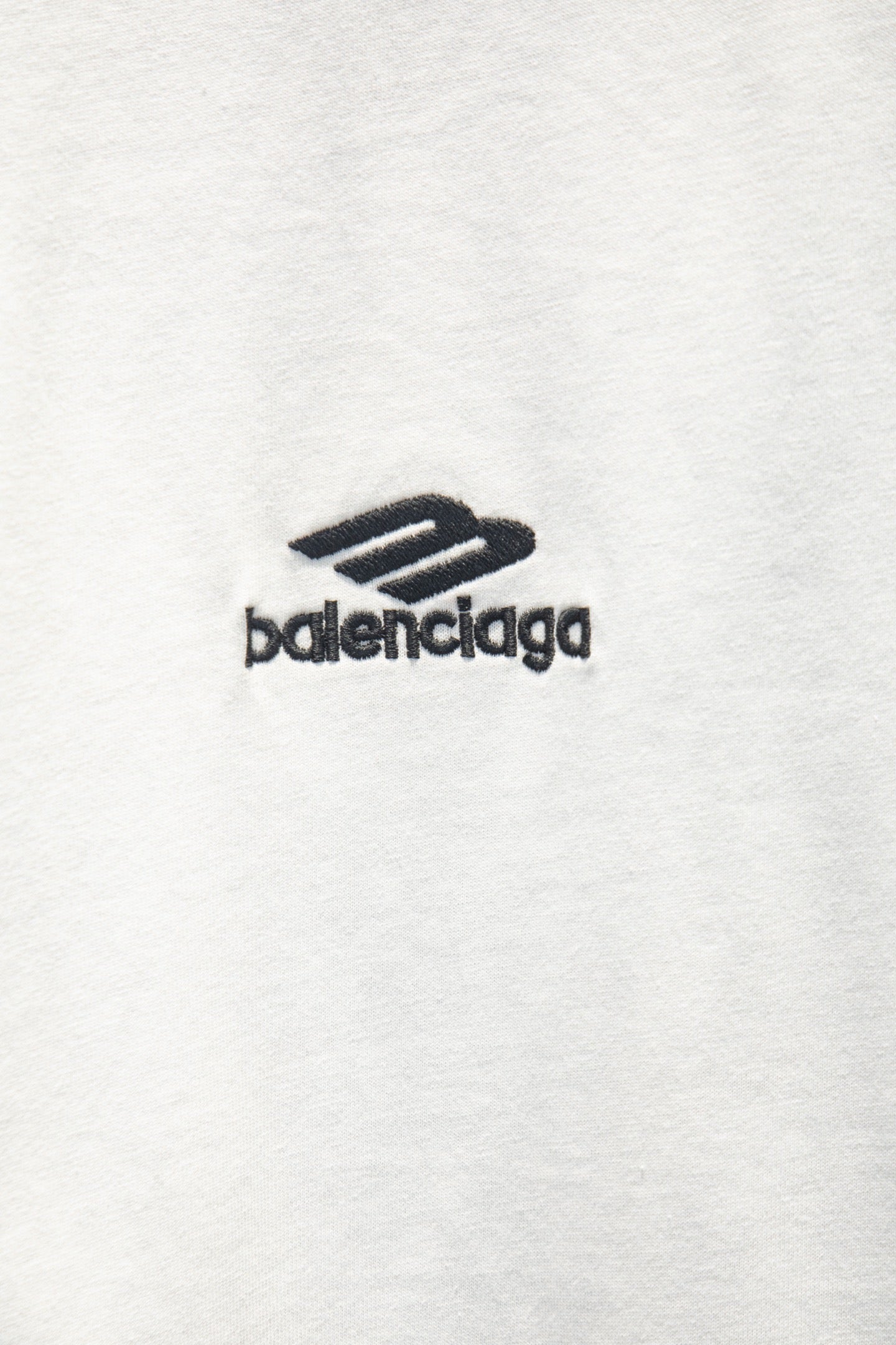 White T-shirt with small black balenciaga logo mark.