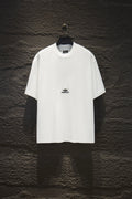 White Balenciaga short-sleeve T-shirt on hanger, small chest logo.