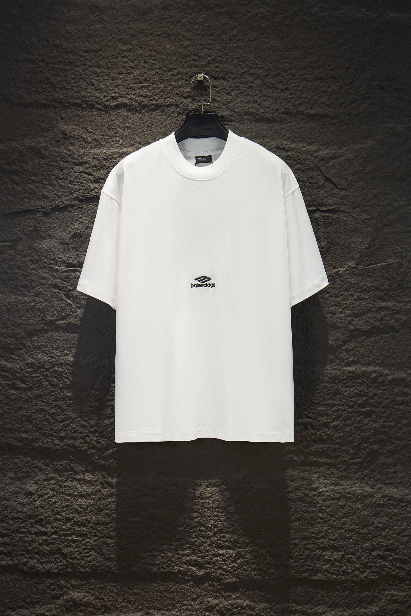 White Balenciaga short-sleeve T-shirt on hanger, small chest logo.