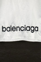 White T-shirt with black balenciaga logo lettering near bottom edge.