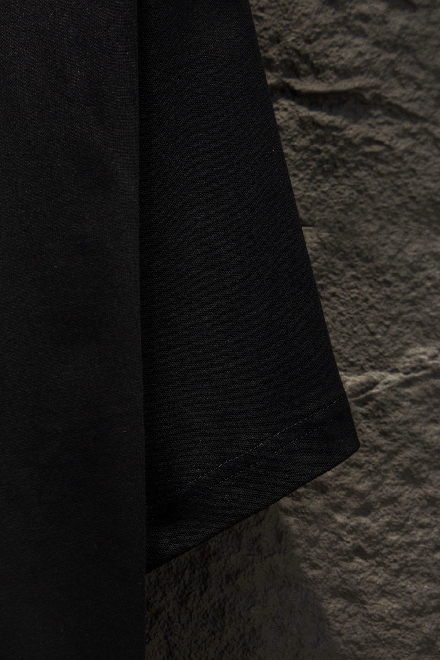 Balenciaga black short-sleeve T-shirt, side view of hem and sleeve