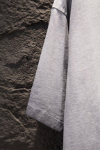 Light gray T-shirt side view with short sleeves and straight hem