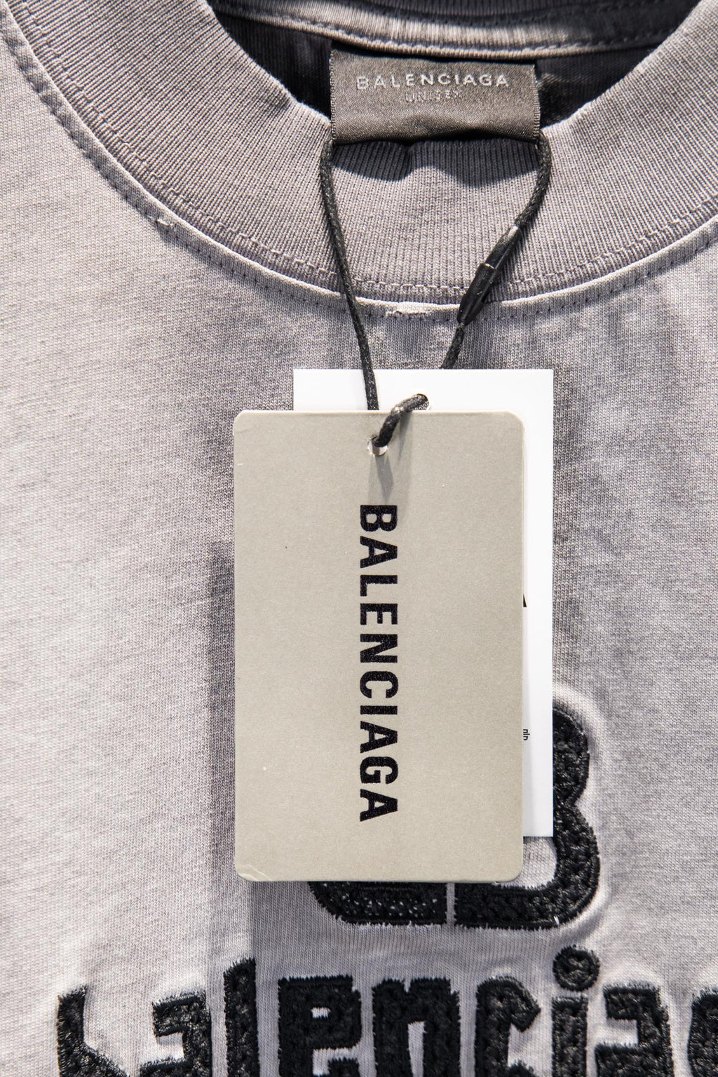 Light gray T-shirt neckline with Balenciaga hang tag