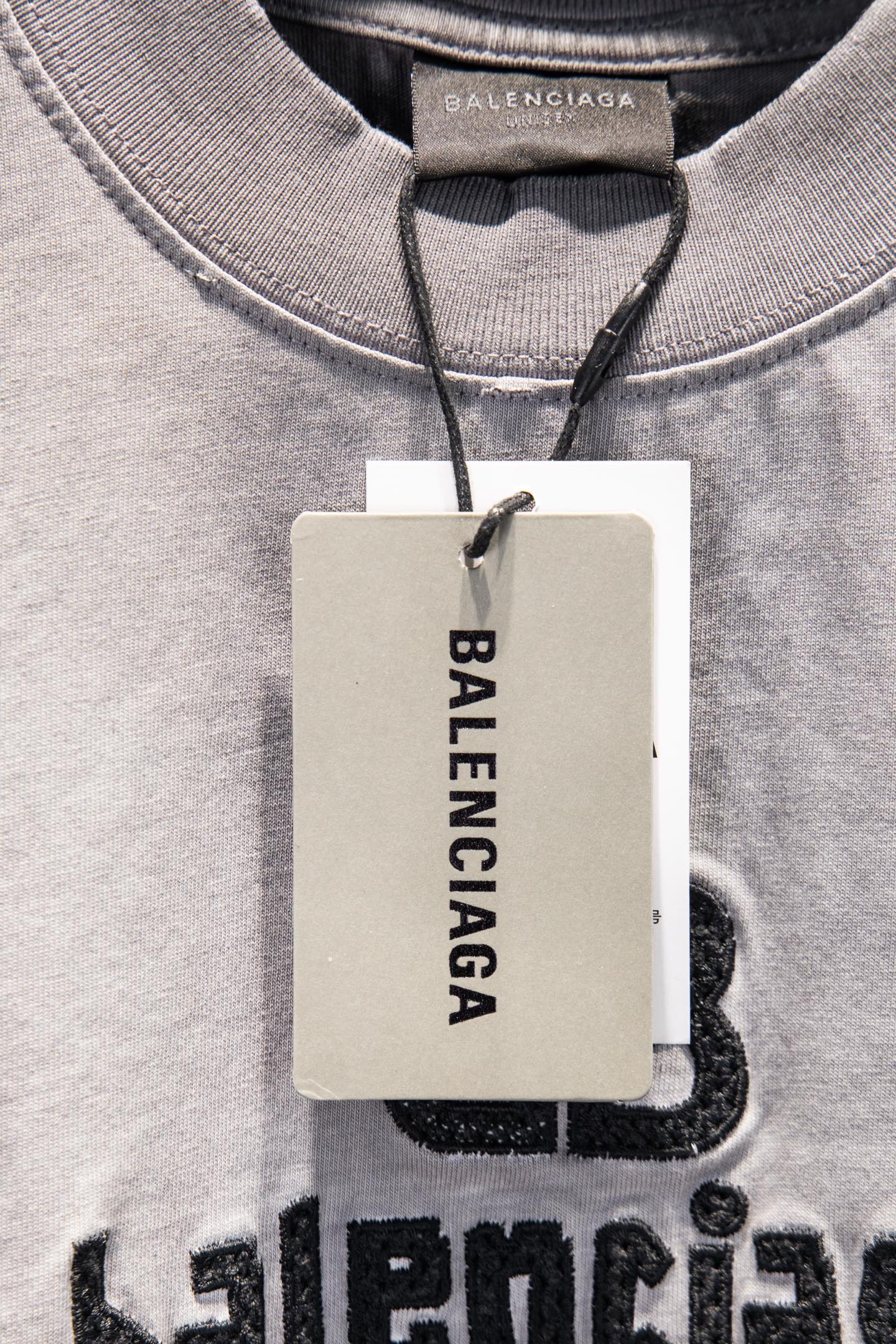 Light gray T-shirt neckline with Balenciaga hang tag