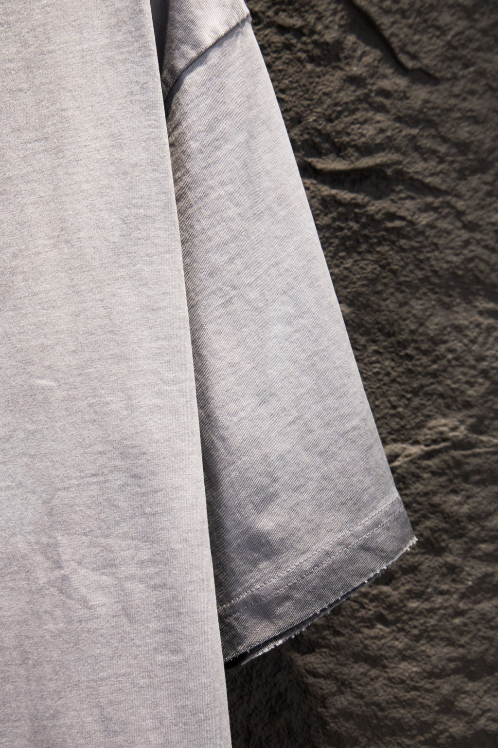 Light gray T-shirt with draped sleeve and side seam detail