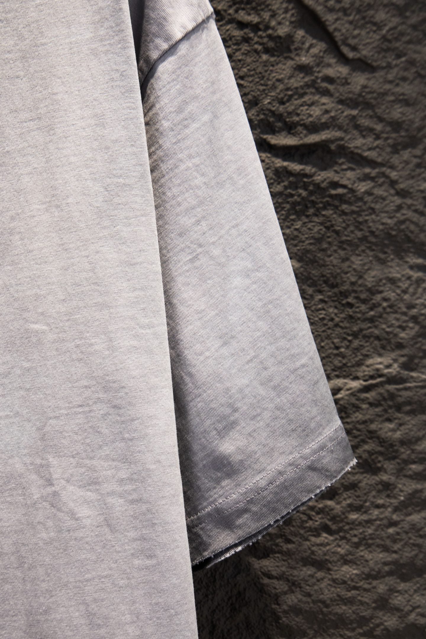 Light gray T-shirt with draped sleeve and side seam detail