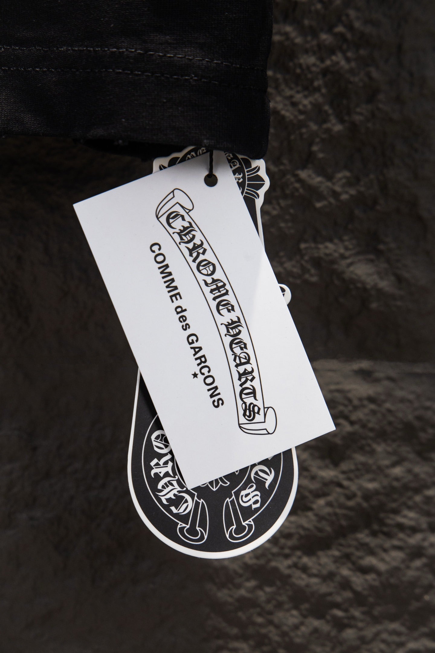 Black T-shirt with hanging white garment tag