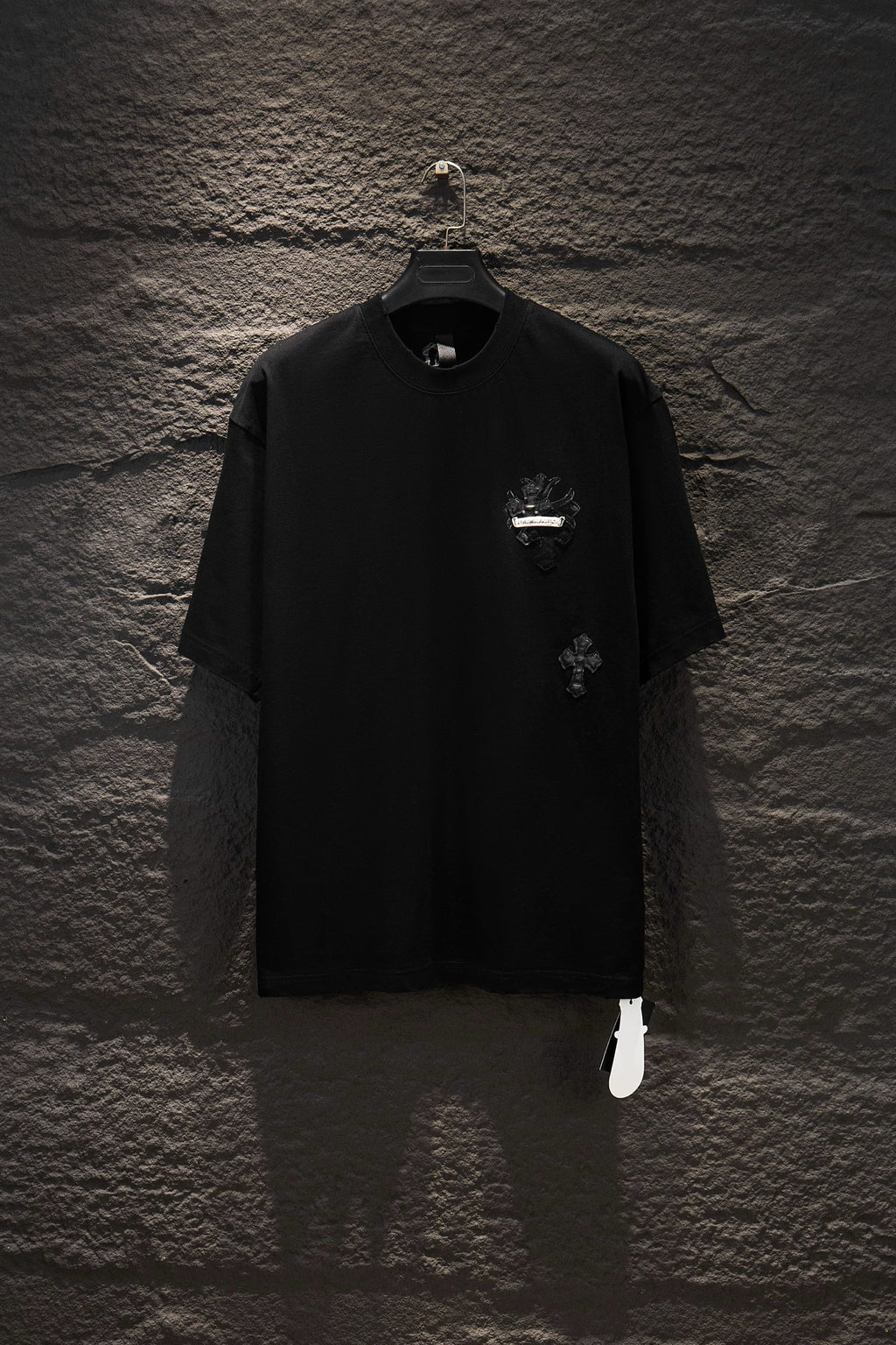 Black short-sleeve T-shirt with small chest graphic and round neckline