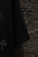 Black T-shirt sleeve with stitched hem and small side logo