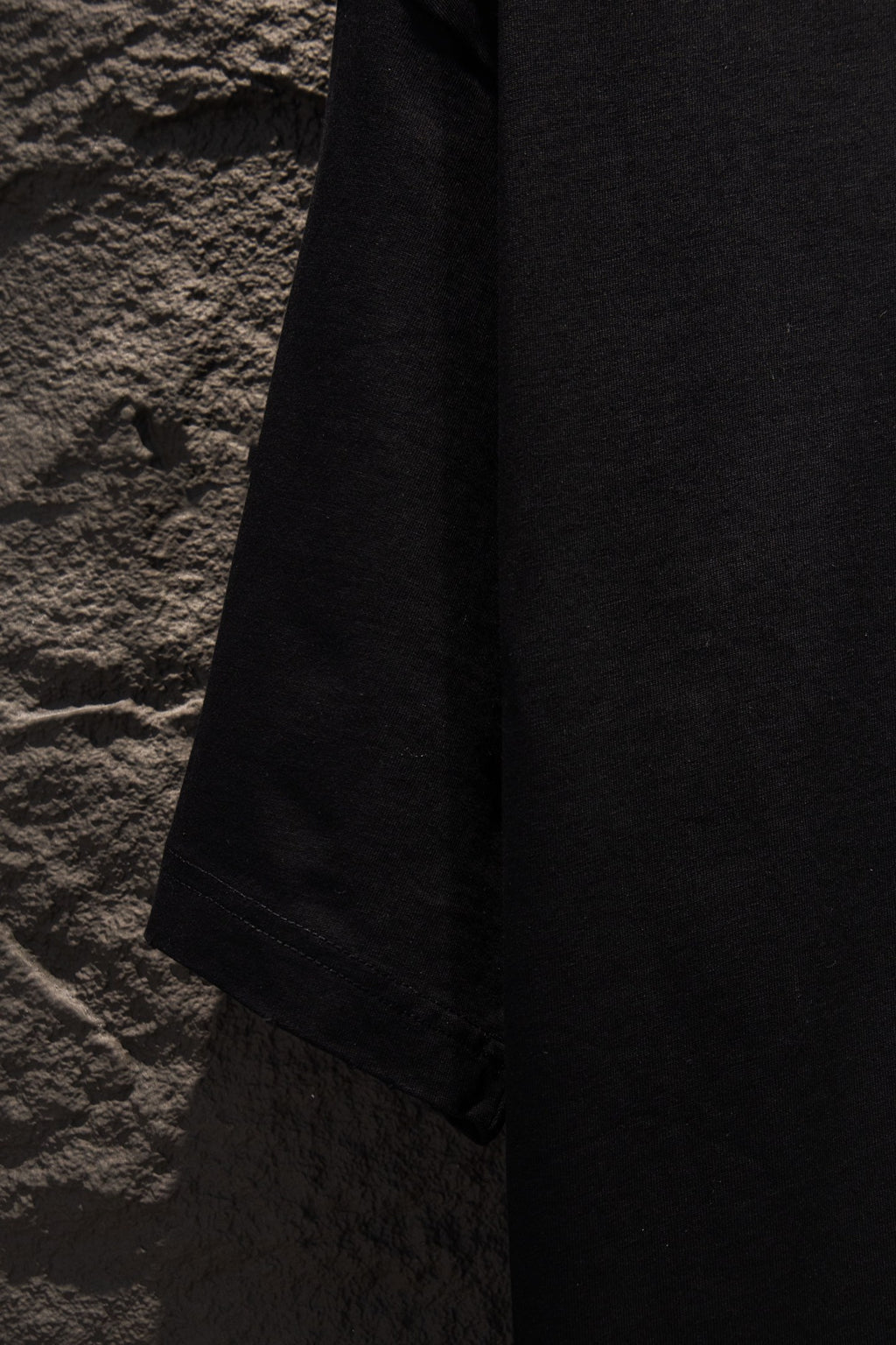 Black T-shirt hem with stitched edge