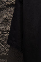 Black T-shirt hem with stitched edge
