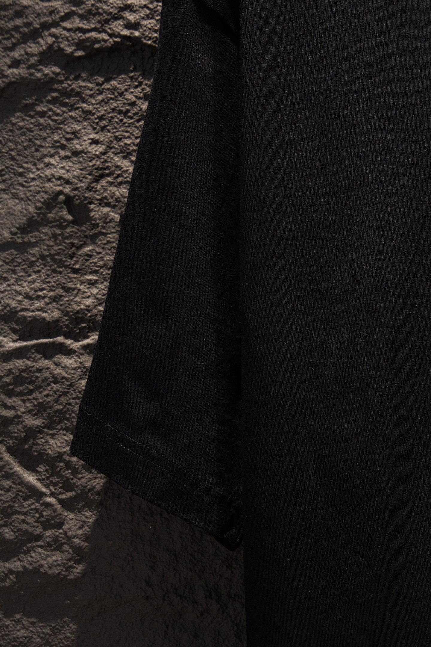 Black T-shirt hem with stitched edge