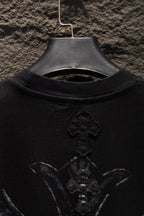 Black T-shirt with large front cross emblem near chest