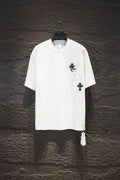 White short-sleeve graphic T-shirt with black cross emblem on the chest