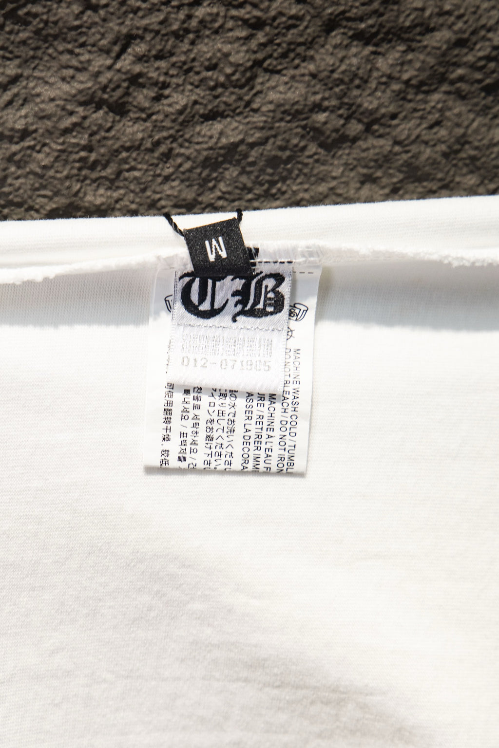 White T-shirt care label inside the neckline with printed text