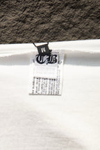 White T-shirt interior with black size label at neckline