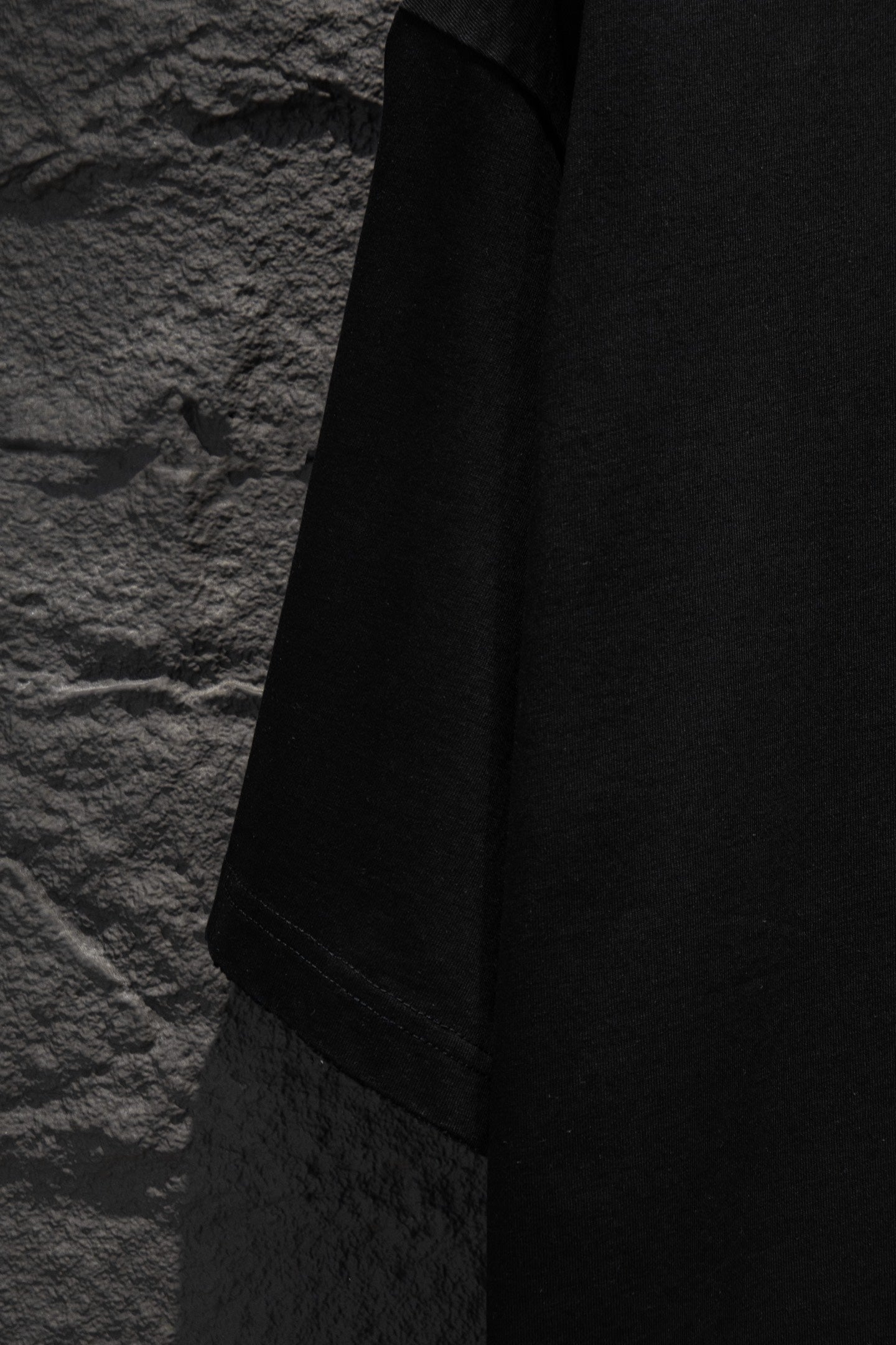 Black T-shirt sleeve and side panel view