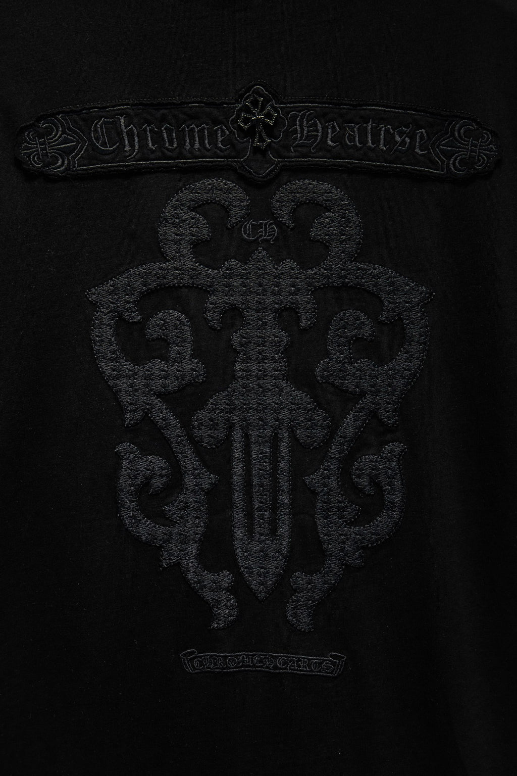 Black T-shirt with large embroidered emblem and ornamental lettering