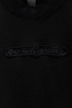 Black T-shirt with detailed embroidered logo across upper chest