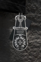 Black T-shirt with attached white emblem hang tag