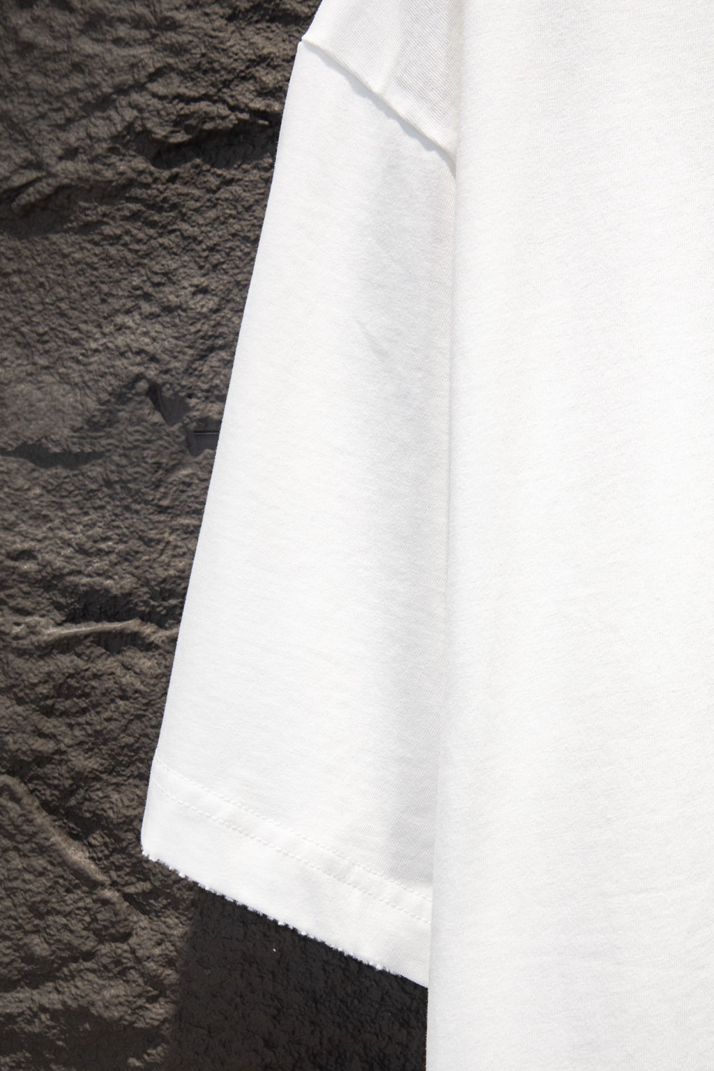White T-shirt sleeve and lower hem close-up