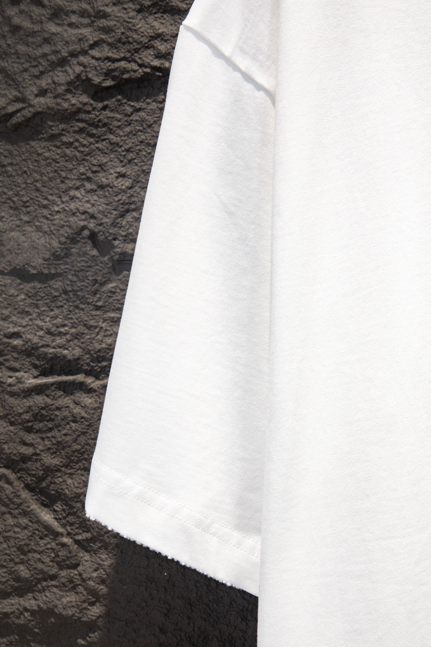 White T-shirt sleeve and lower hem close-up