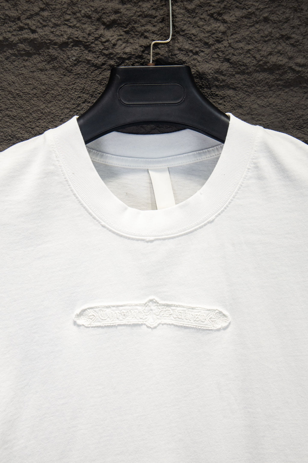 White T-shirt neckline with embossed chest logo detail