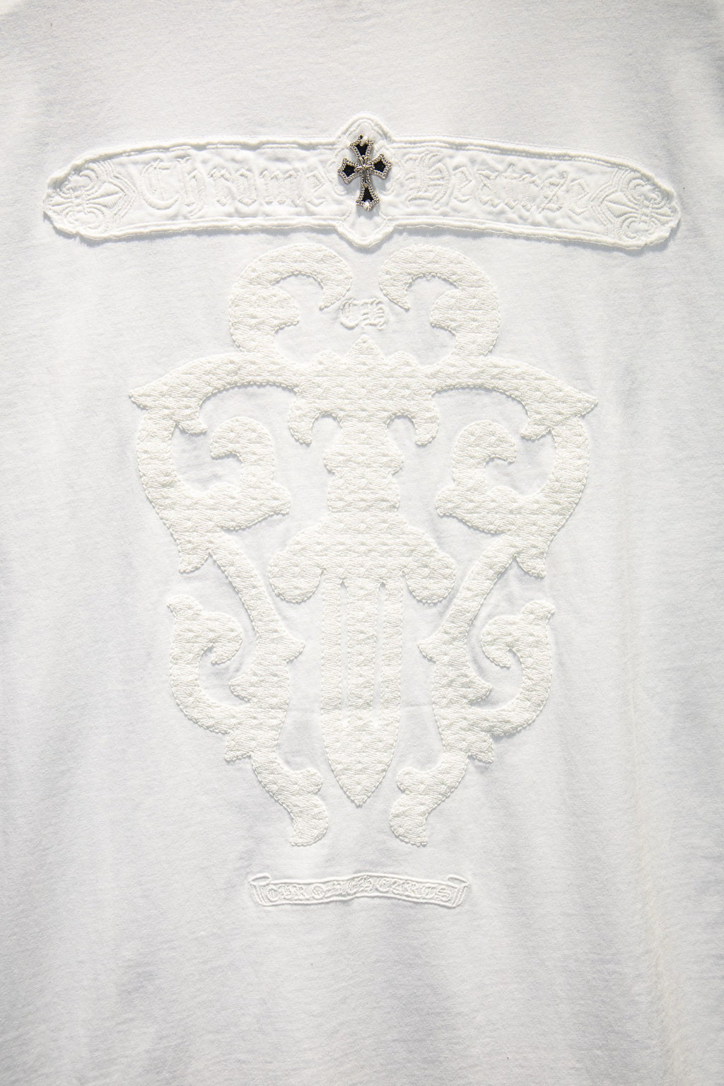 Embossed V-shaped face graphic on white crewneck T-shirt