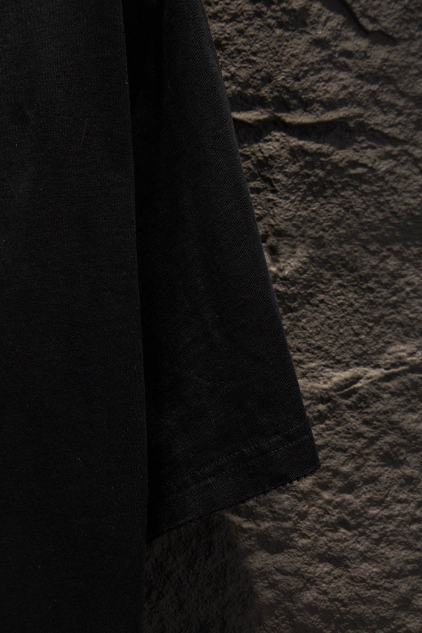 Black T-shirt sleeve hem and lower side view