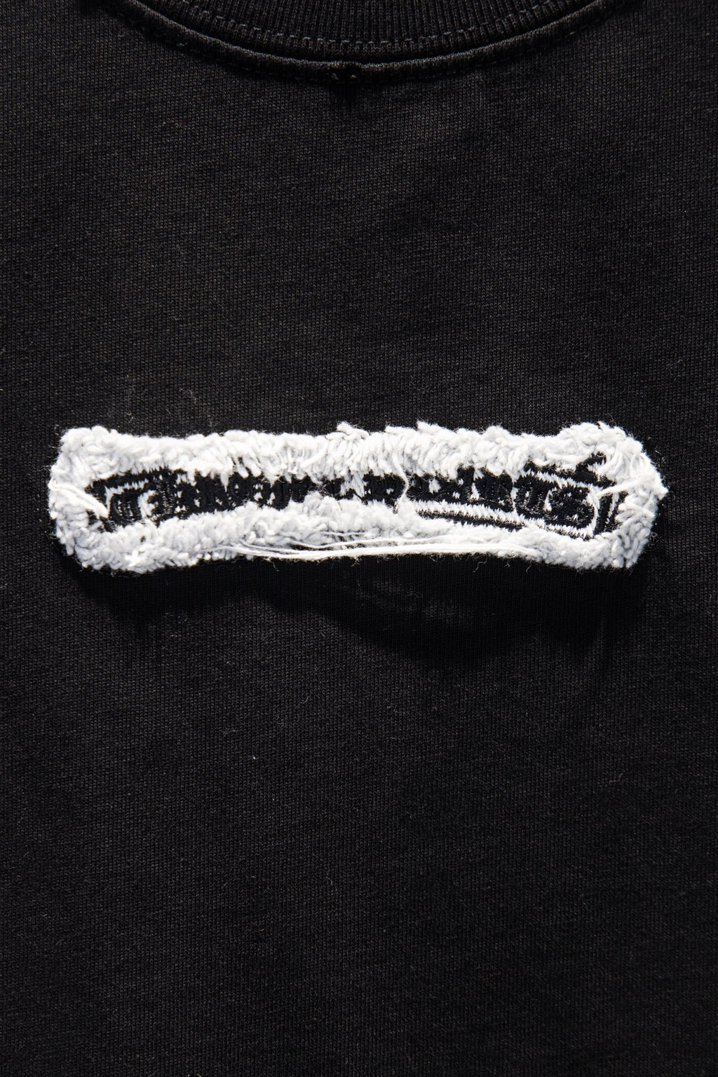 Black T-shirt with white embroidered stripe patch