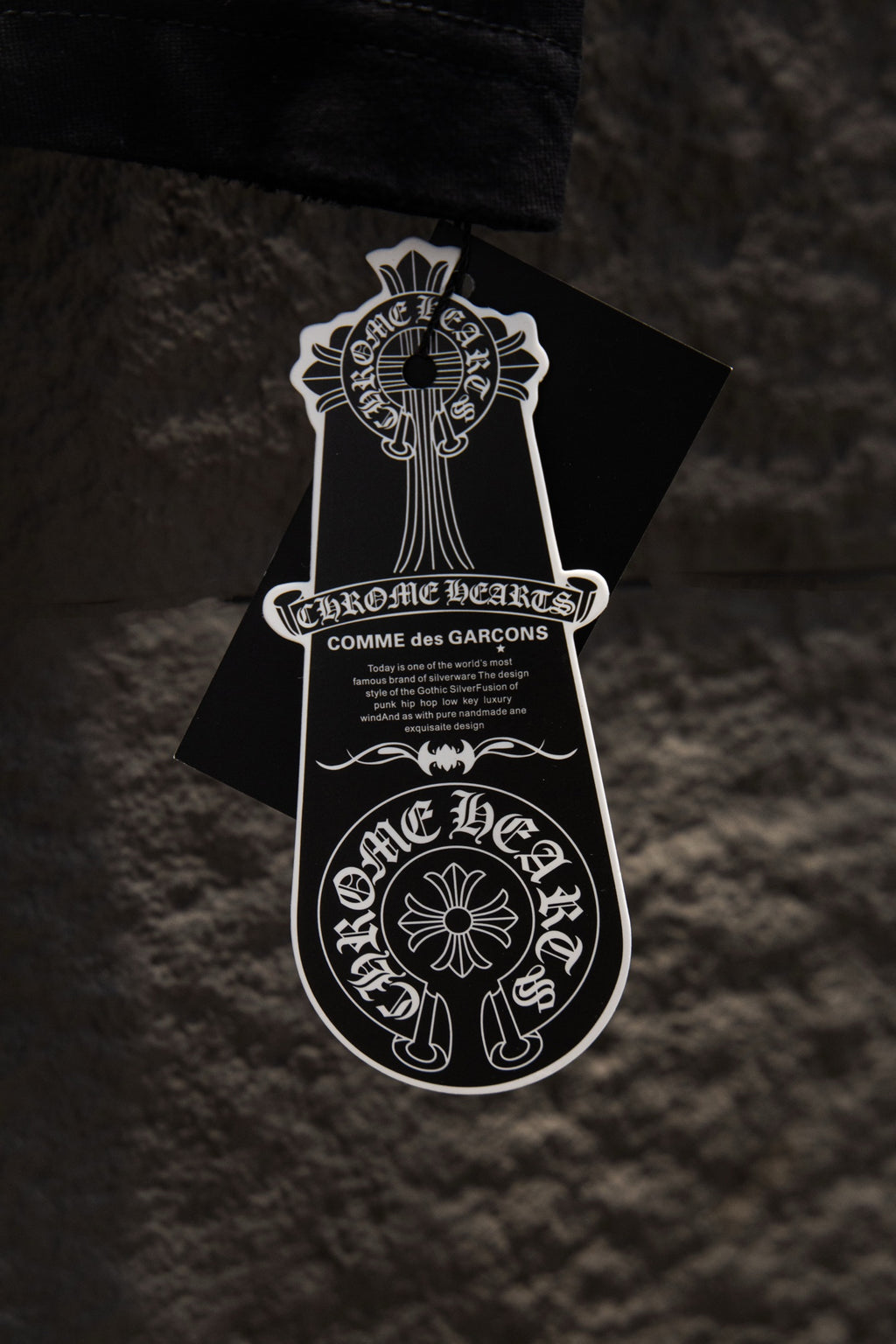 Black T-shirt with Chrome Hearts brand graphic hang tag