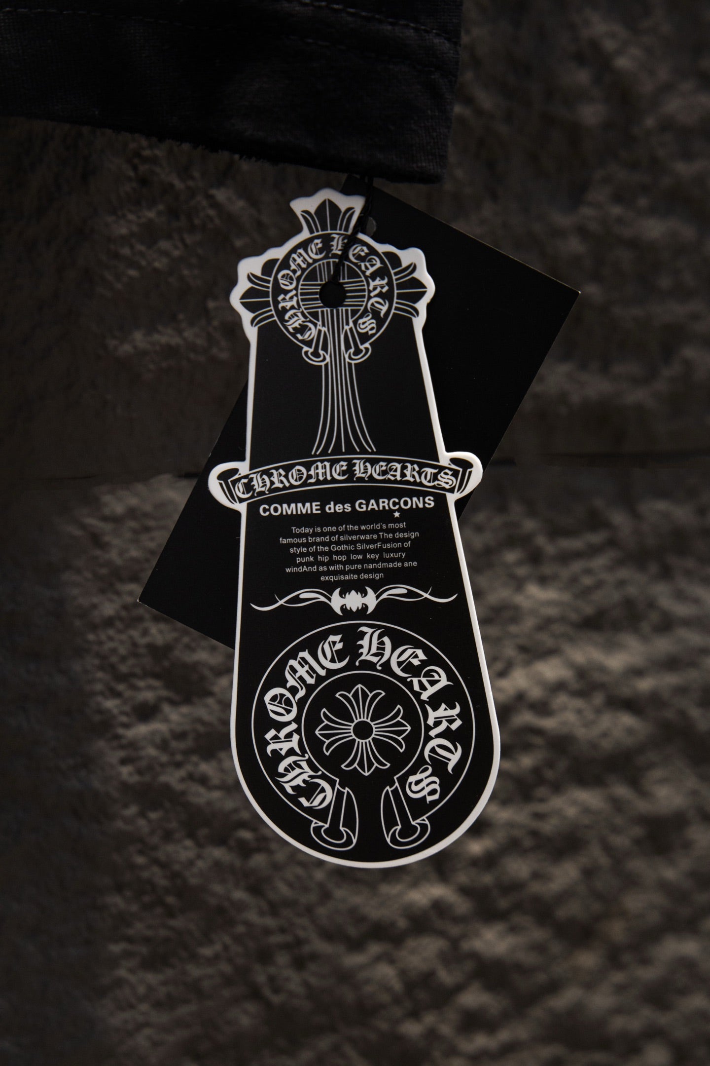 Black T-shirt with Chrome Hearts brand graphic hang tag