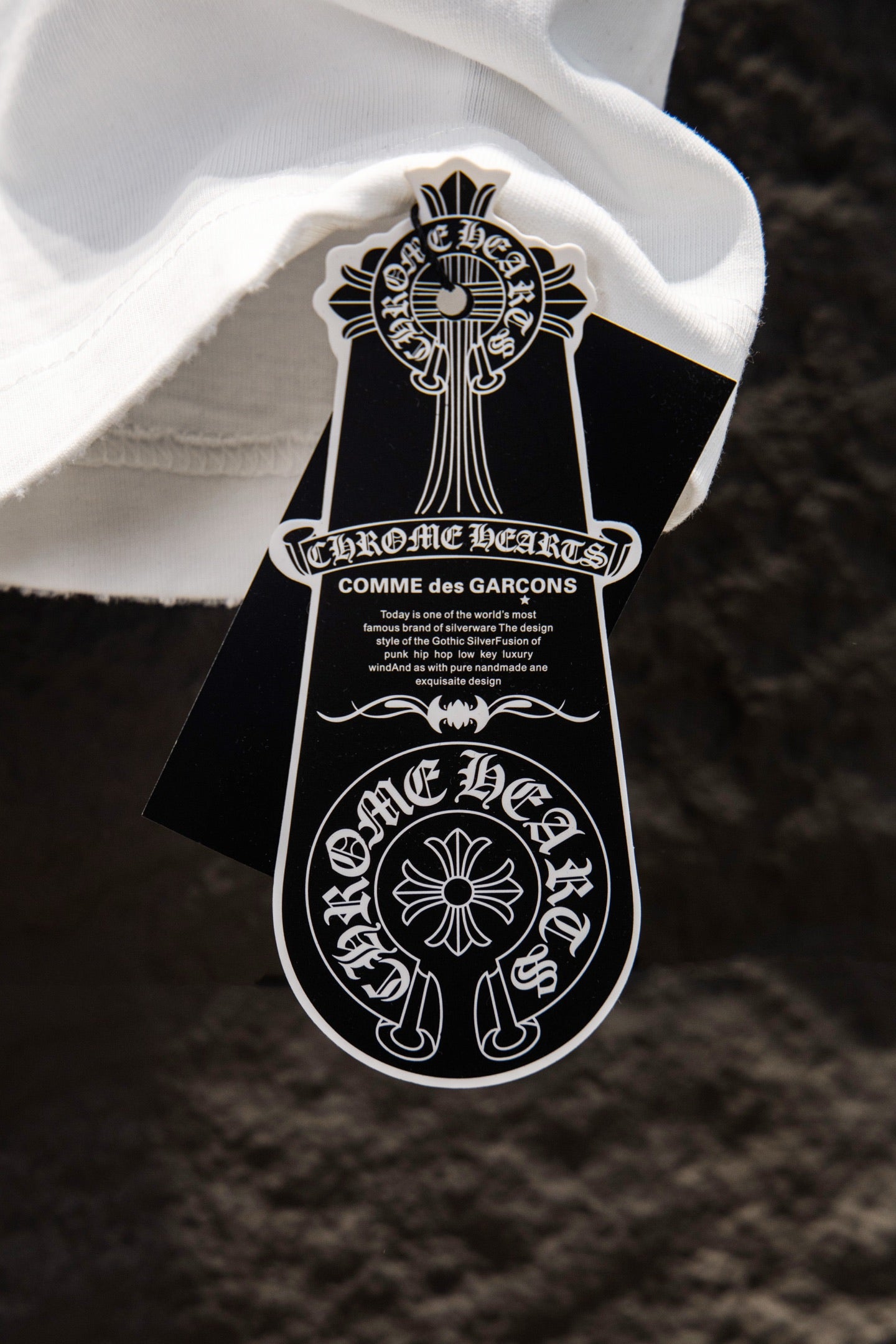 White T-shirt interior neckline with hanging Chrome Hearts tag