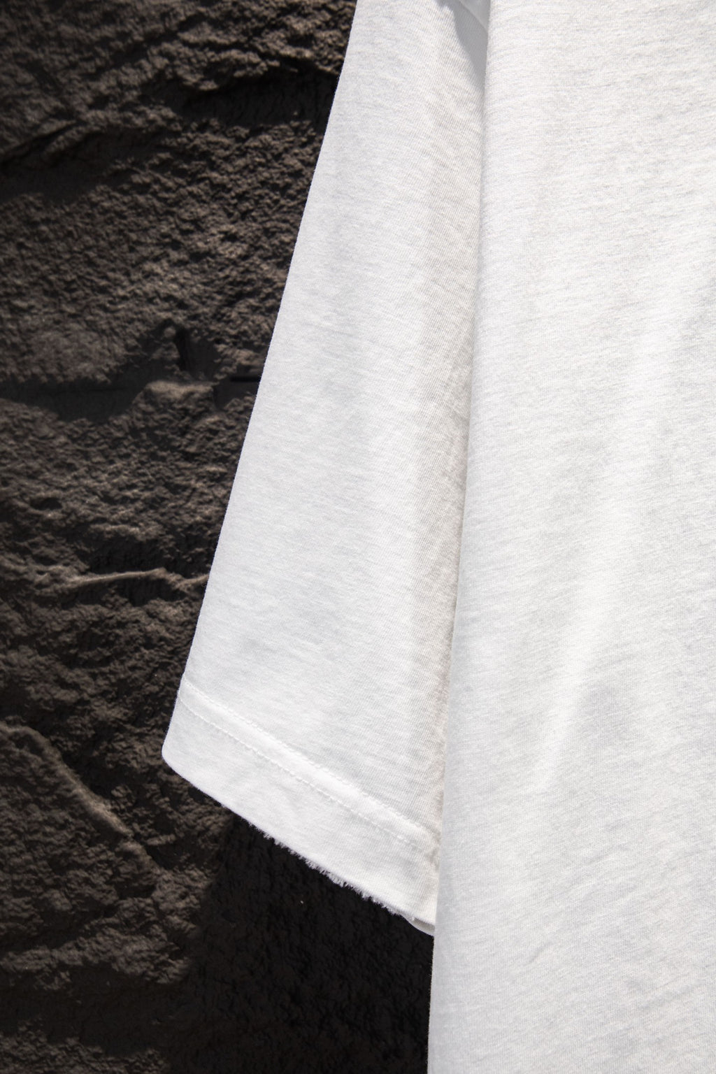 White short-sleeve T-shirt hem and side drape view