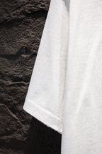 White short-sleeve T-shirt hem and side drape view