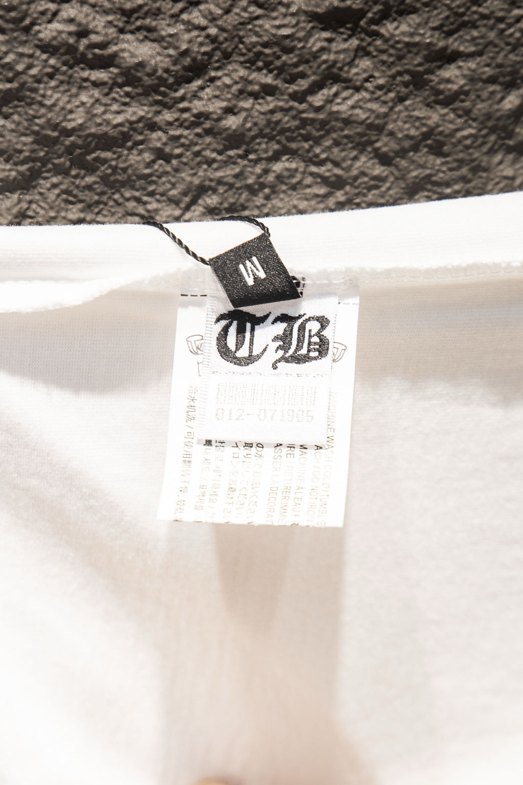 White T-shirt with size care tag at collar area