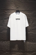 White short-sleeve T-shirt with small black chest logo patch