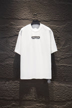 White short-sleeve T-shirt with small black chest logo patch