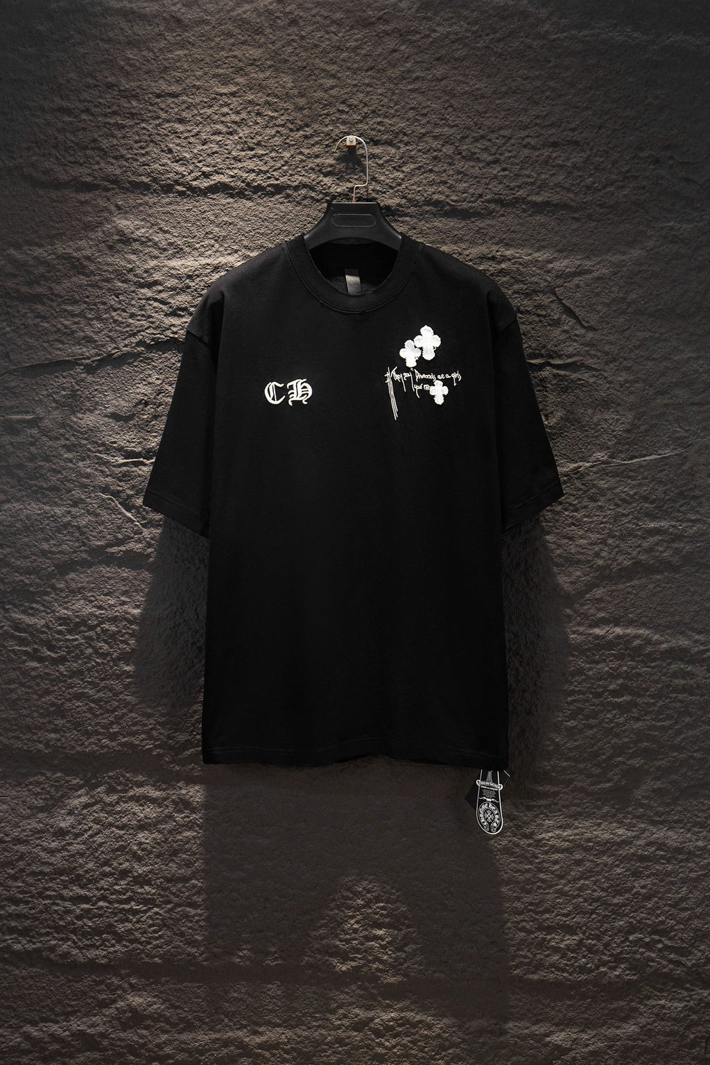 Black short-sleeve T-shirt with white cross and graphic print on chest