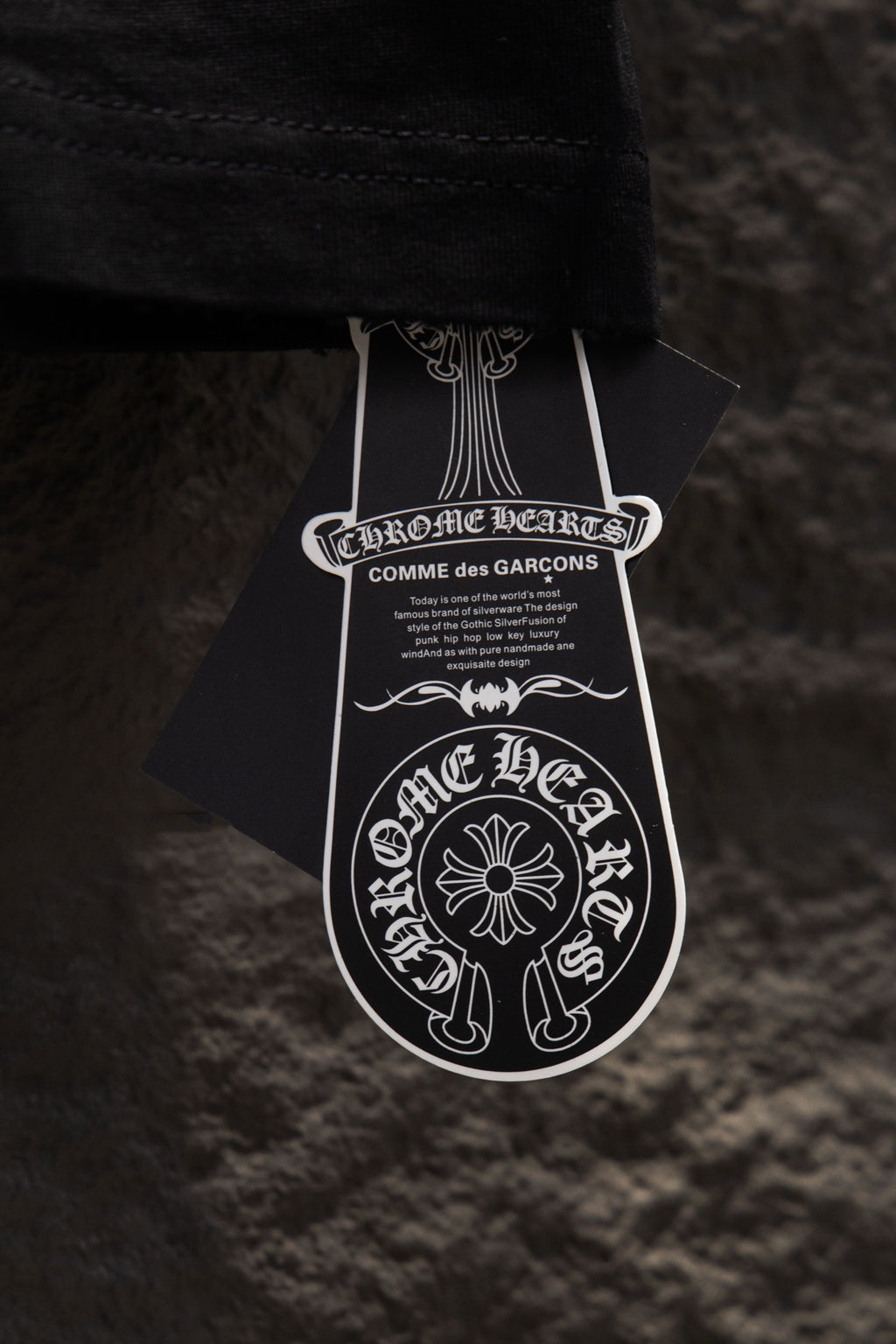 Black short-sleeve T-shirt with white designer hang tag