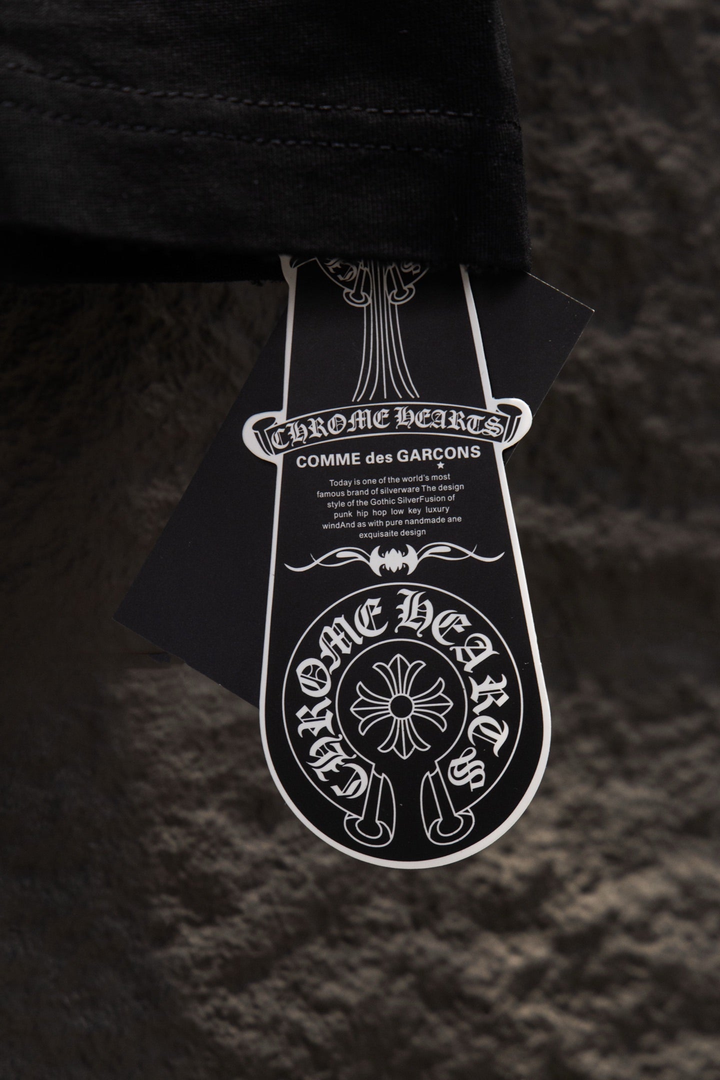 Black short-sleeve T-shirt with white designer hang tag