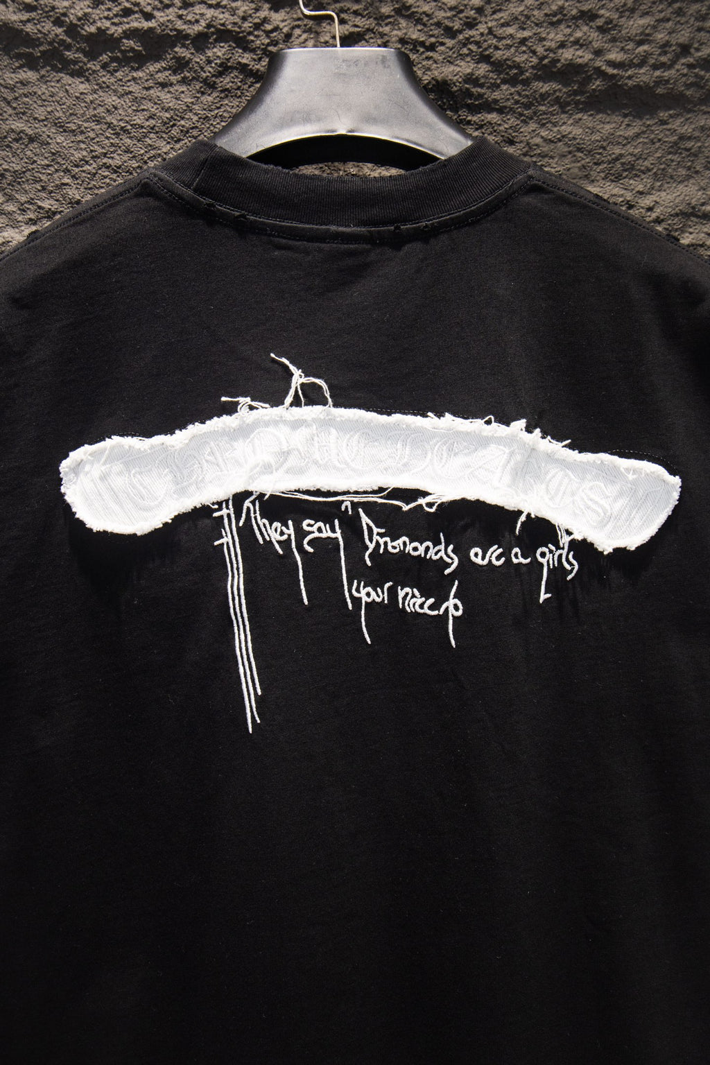 Black short-sleeve T-shirt front with large white horizontal cross graphic