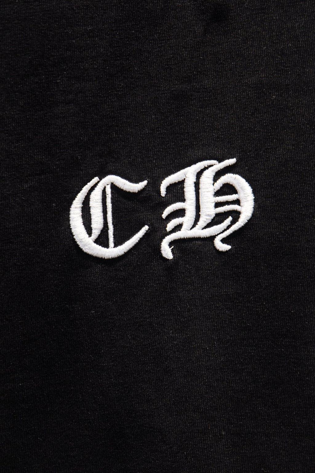 Black short-sleeve T-shirt close-up of white C B emblem