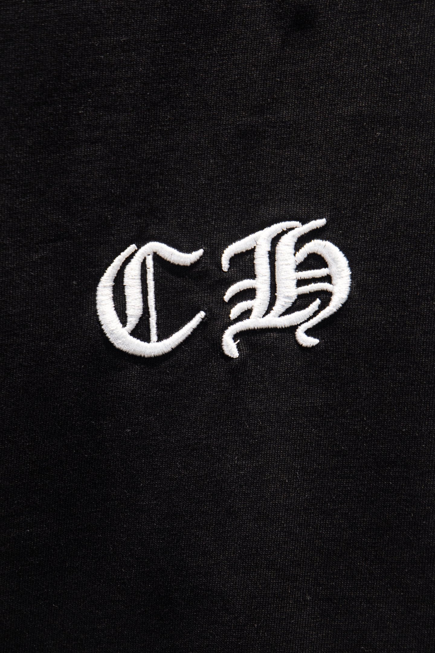 Black short-sleeve T-shirt close-up of white C B emblem