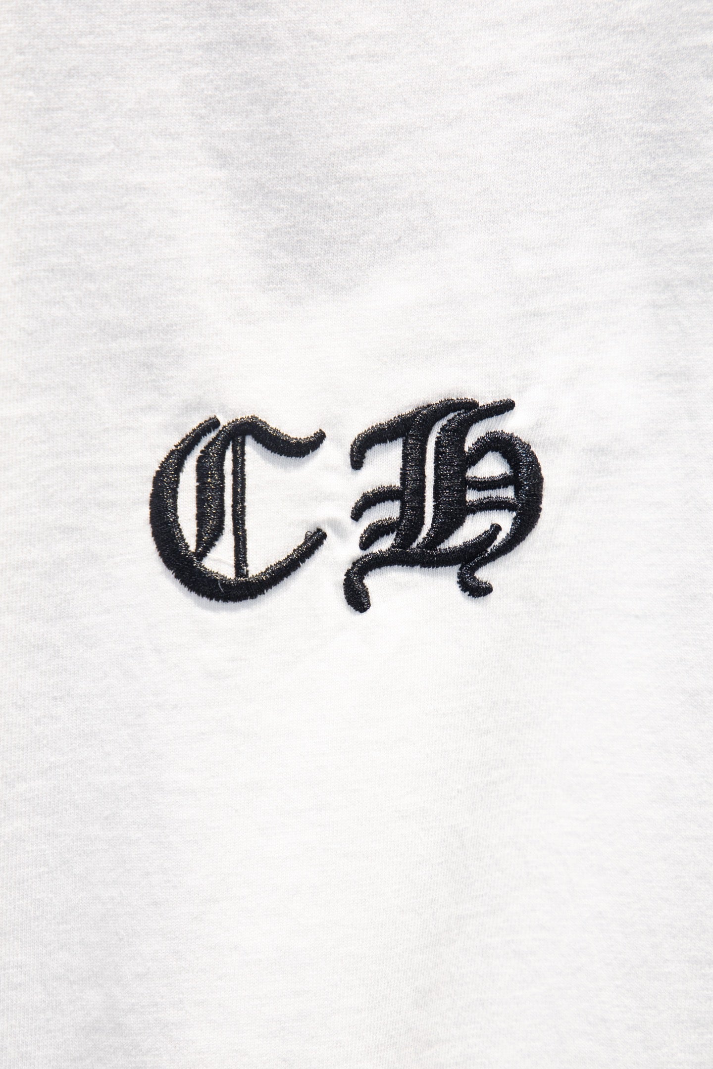 White short-sleeve T-shirt with black stylized monogram logo.